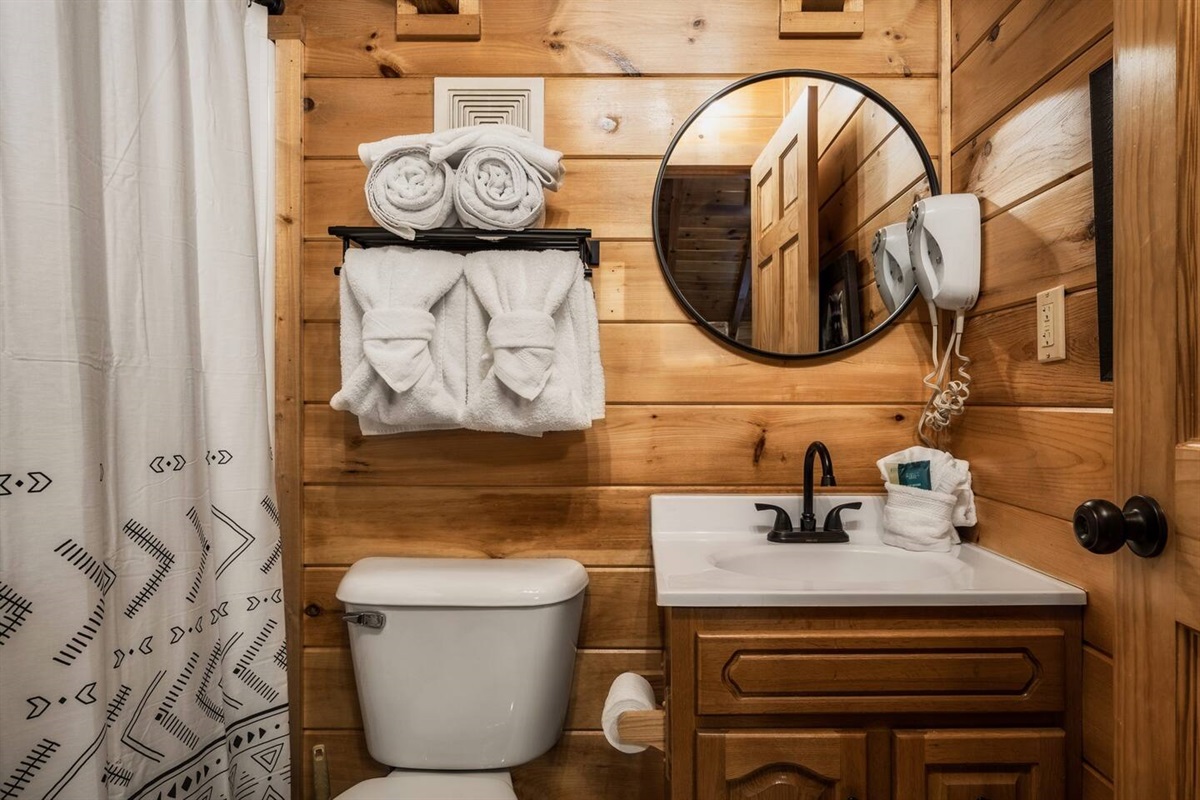 Modern bathroom with hardwood walls and a wonderfully made sink.