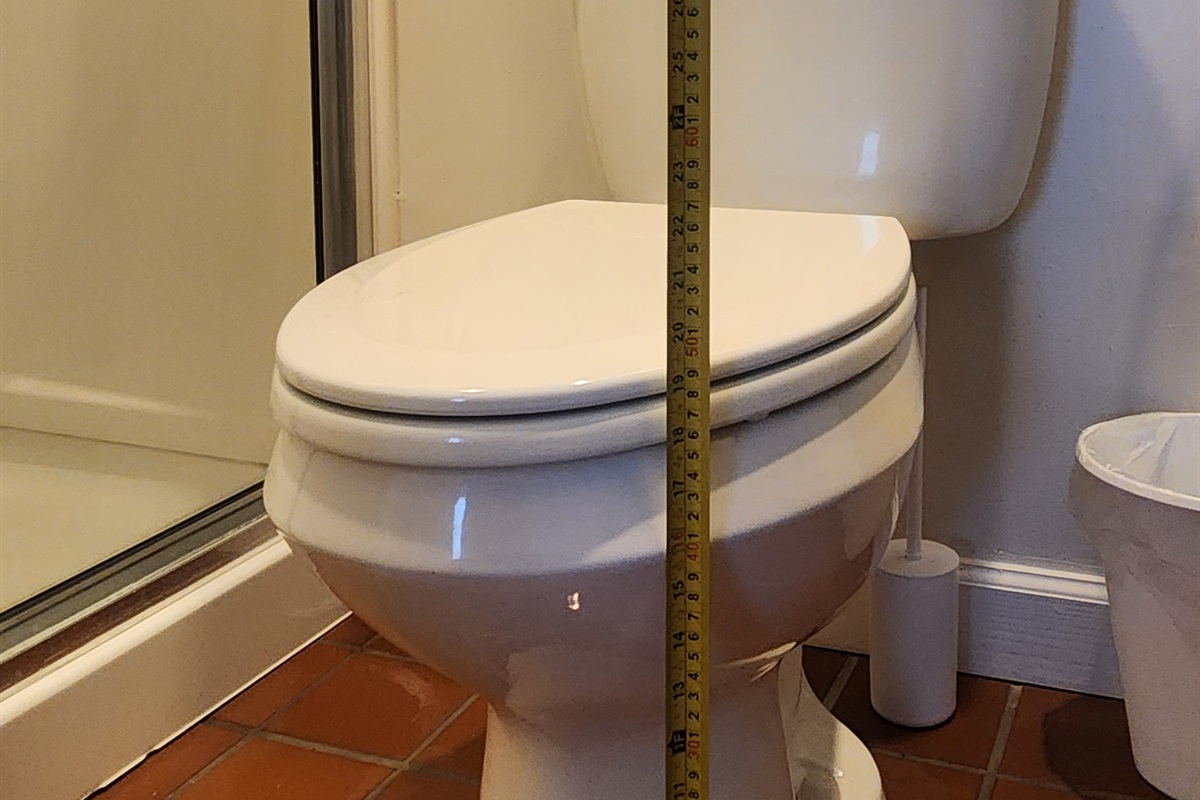 Toilet seat height measured from the floor for reference