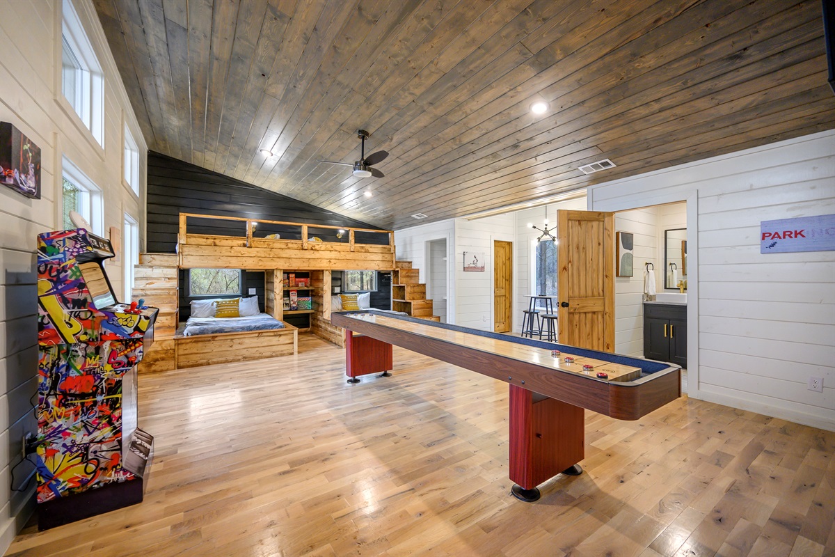 A lively game area featuring over 100 arcade games and a shuffleboard table — perfect for endless entertainment, friendly competition, and group fun indoors. 🎮🏓✨