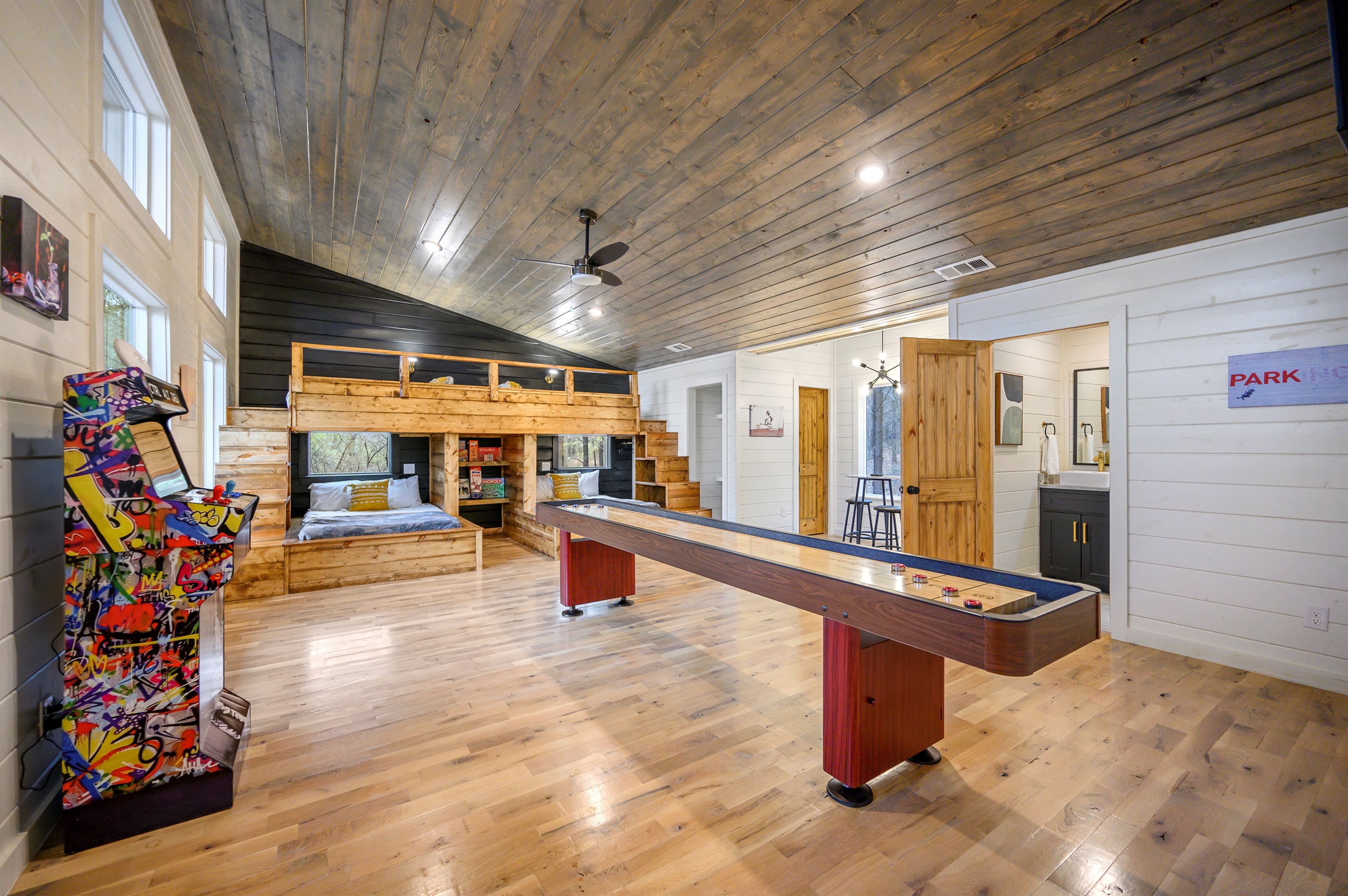 A lively game area featuring over 100 arcade games and a shuffleboard table — perfect for endless entertainment, friendly competition, and group fun indoors. 🎮🏓✨