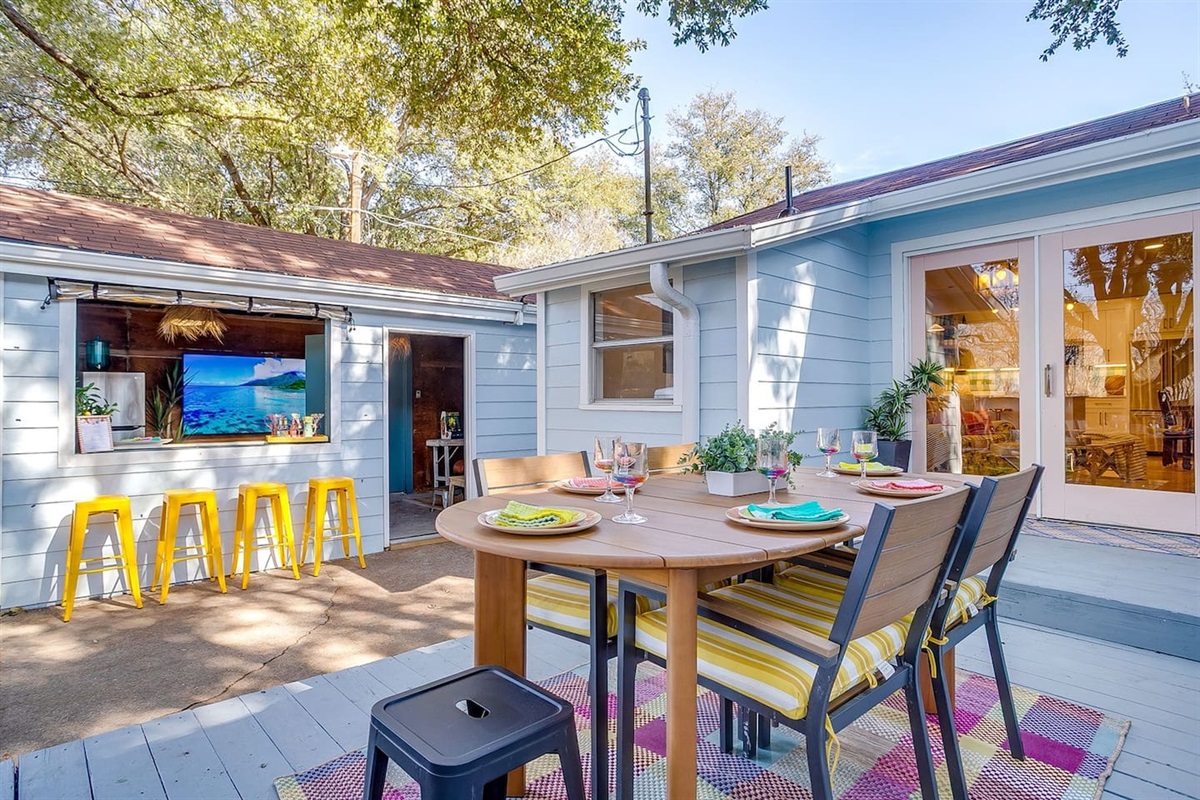 Outdoor bar seating, lounge space, and 72” pivoting TV