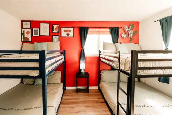 A bunk bed for dreams and whispers, with a TV and lamp nearby for late-night movies and bedtime stories.
