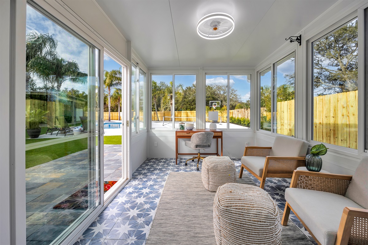 Sunroom with backyard views, a quiet reading nook, and a desk to work with a view