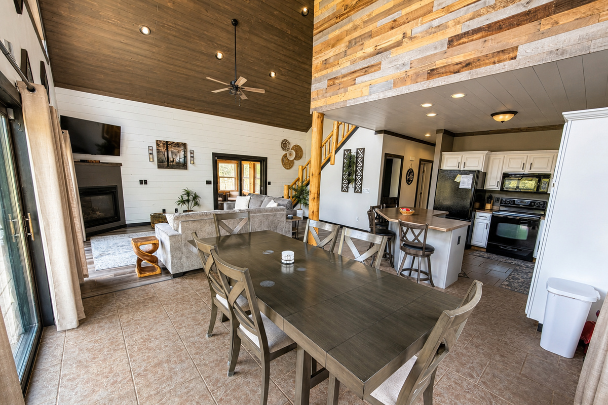 Large dining table sits at the heart of the open living space, making group meals and game nights easy for everyone. The island adds extra seating for large groups.