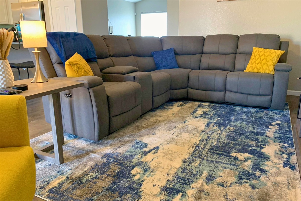 Entertainment setup with large Roku TV and electric fireplace in a clean, modern setting. 