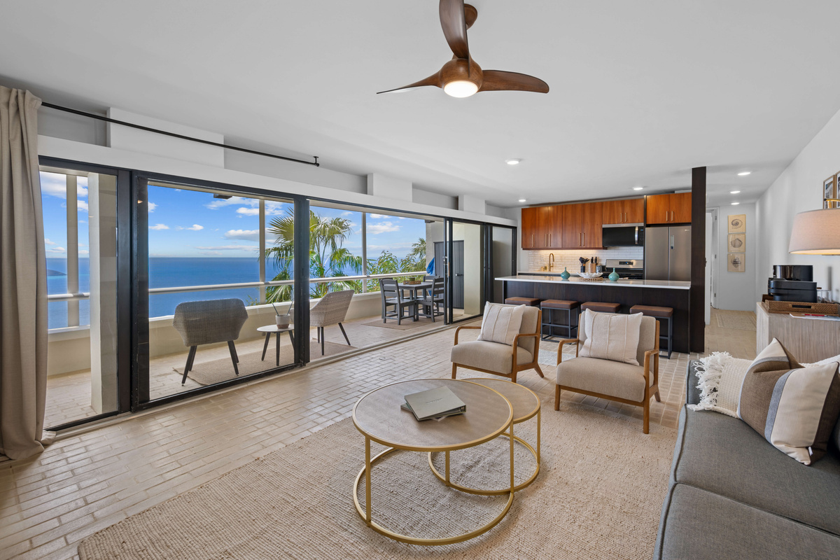 Living room with incredible views and modern furnishings. Includes a queen sleeper sofa, ceiling fan, air conditioning, smart TV, and coffee bar!