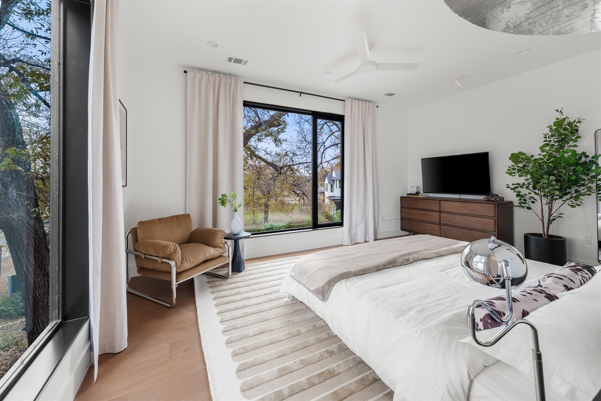 Spacious bedroom retreat with modern furnishings and scenic outdoor views—ideal for unwinding in comfort and privacy.