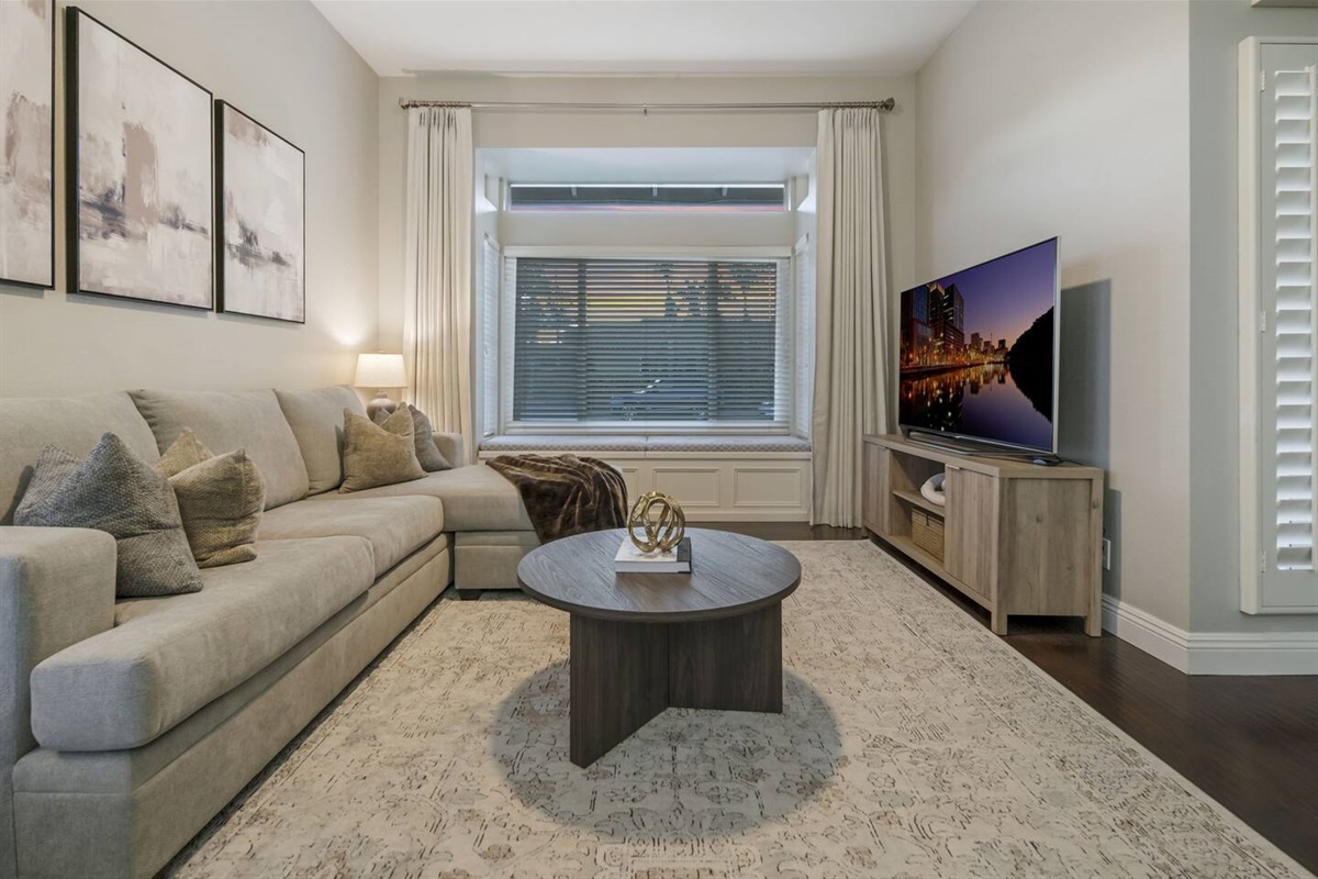 The living room has window seating and storage.