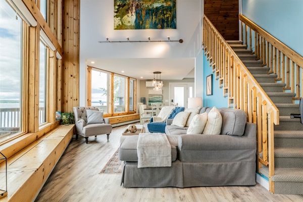 Enjoy stunning panoramic views from this vaulted living room that boasts floor to ceiling windows.