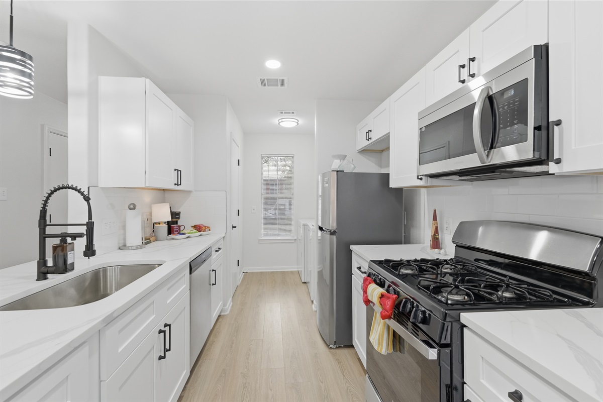 fully stocked kitchen, pots, pans, range, frig,