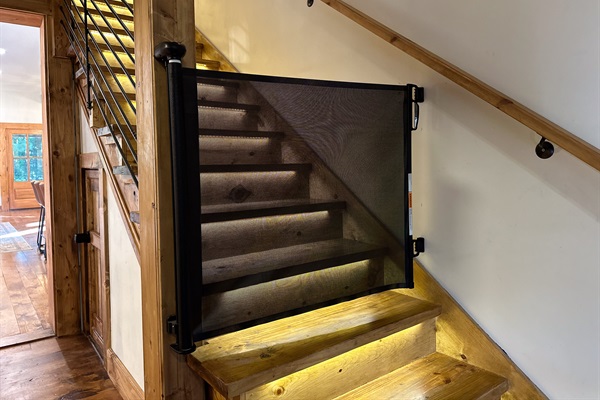 Retractable safety gates at the top and bottom of stairs ease your mine on  vacations with little ones