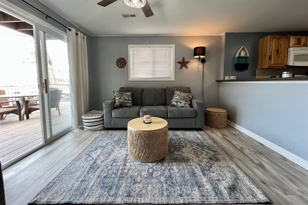 Living Room with queen sleeper sofa. Walk out to the deck and view our cove.