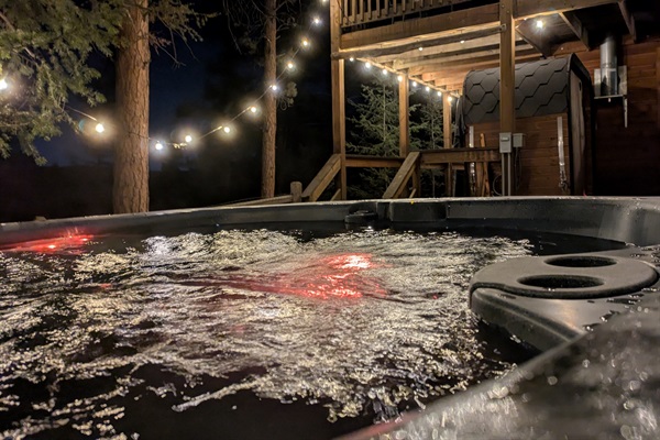 Private hot tub under the pines with string lights ✨—unwind with bubbling soaks, fresh mountain air, and peaceful forest views