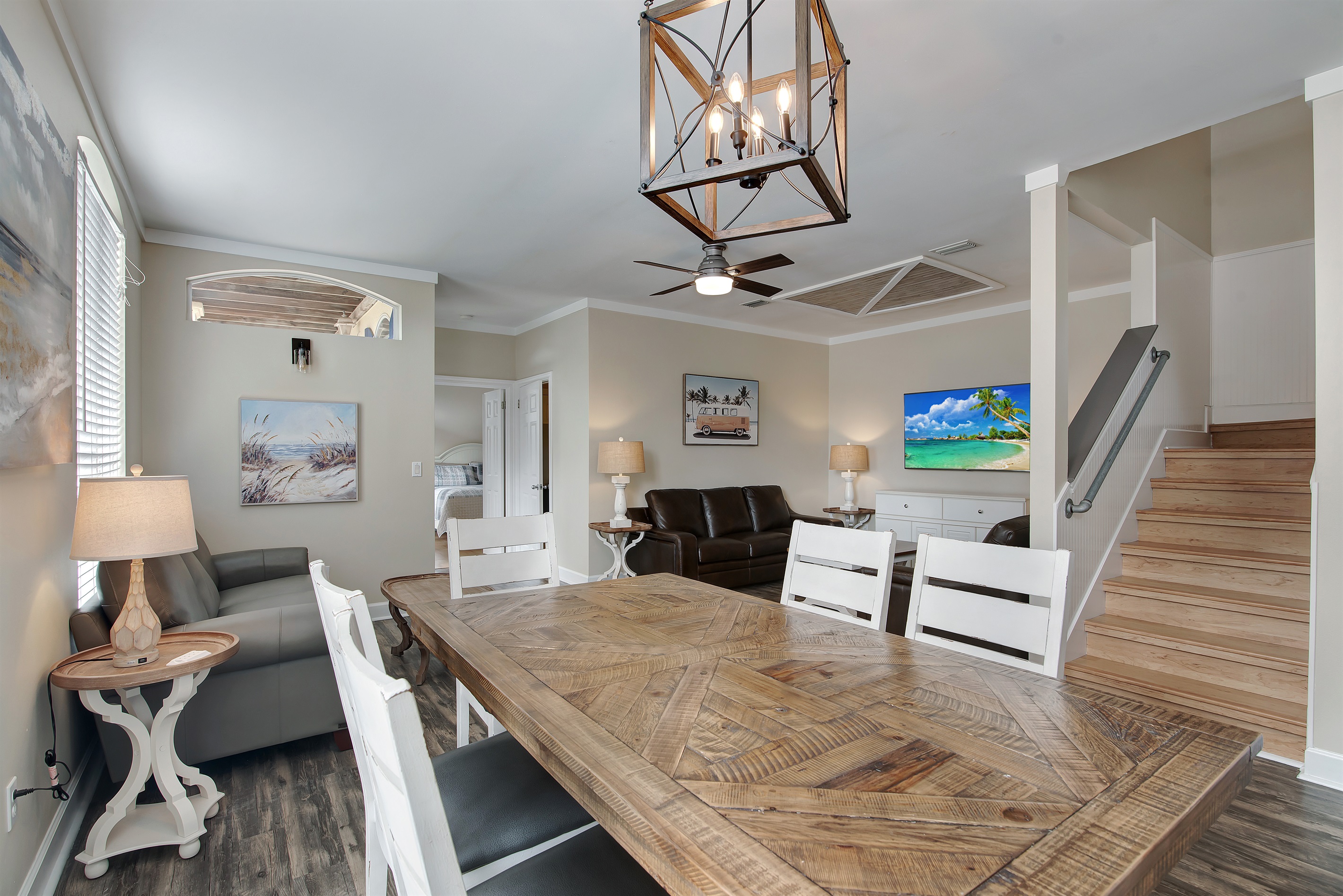 Living room with comfortable seating and coastal artwork