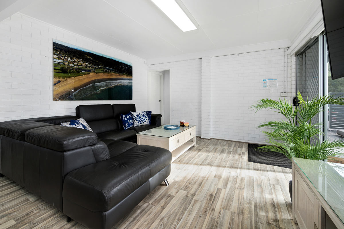 A second living room helps Skye’s Beach House feel flexible across both levels, with this downstairs lounge adding another relaxed zone.
