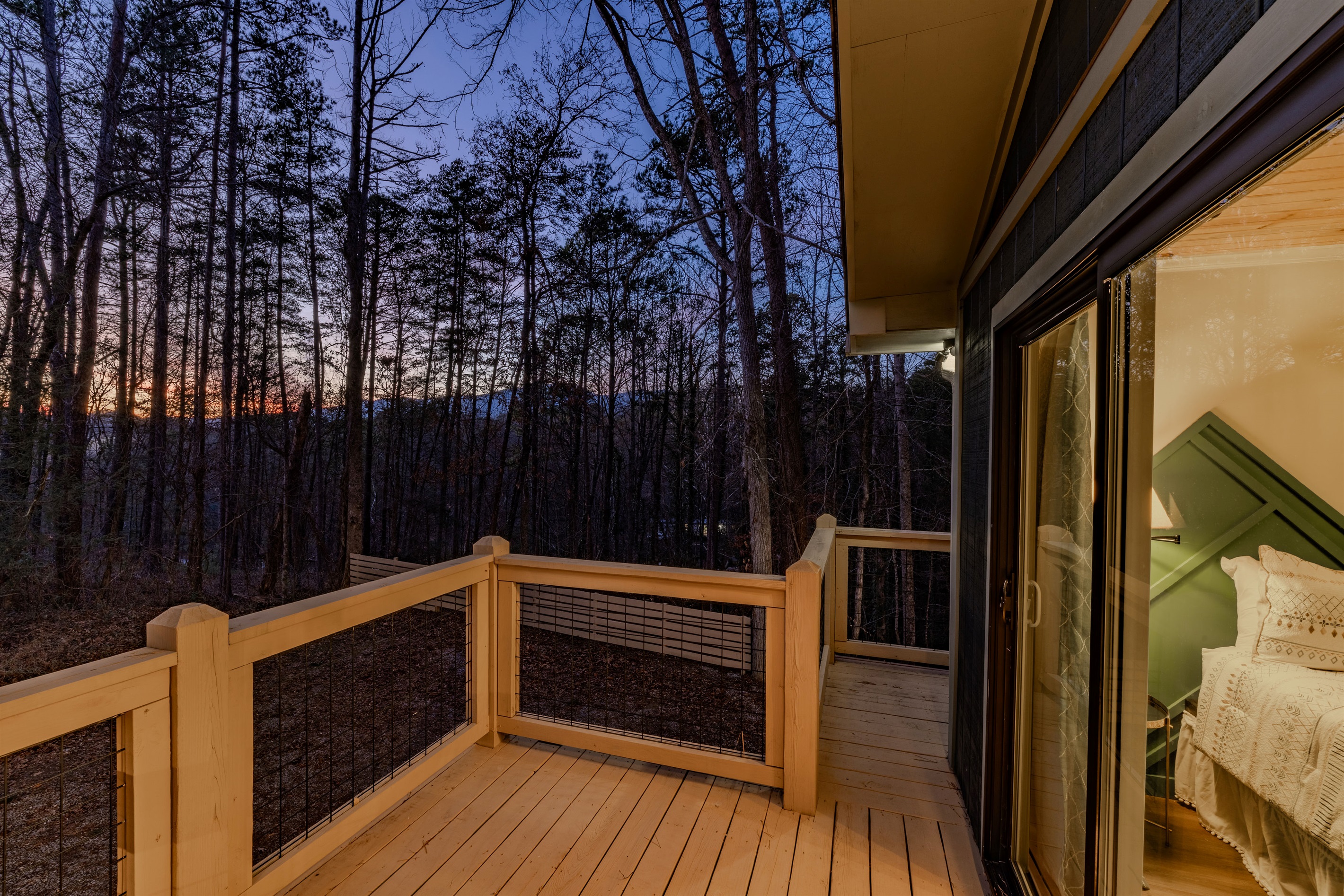 Evening magic at the cabin begins here. Enjoy the soft glow of the interior against the deep blues of a mountain dusk.