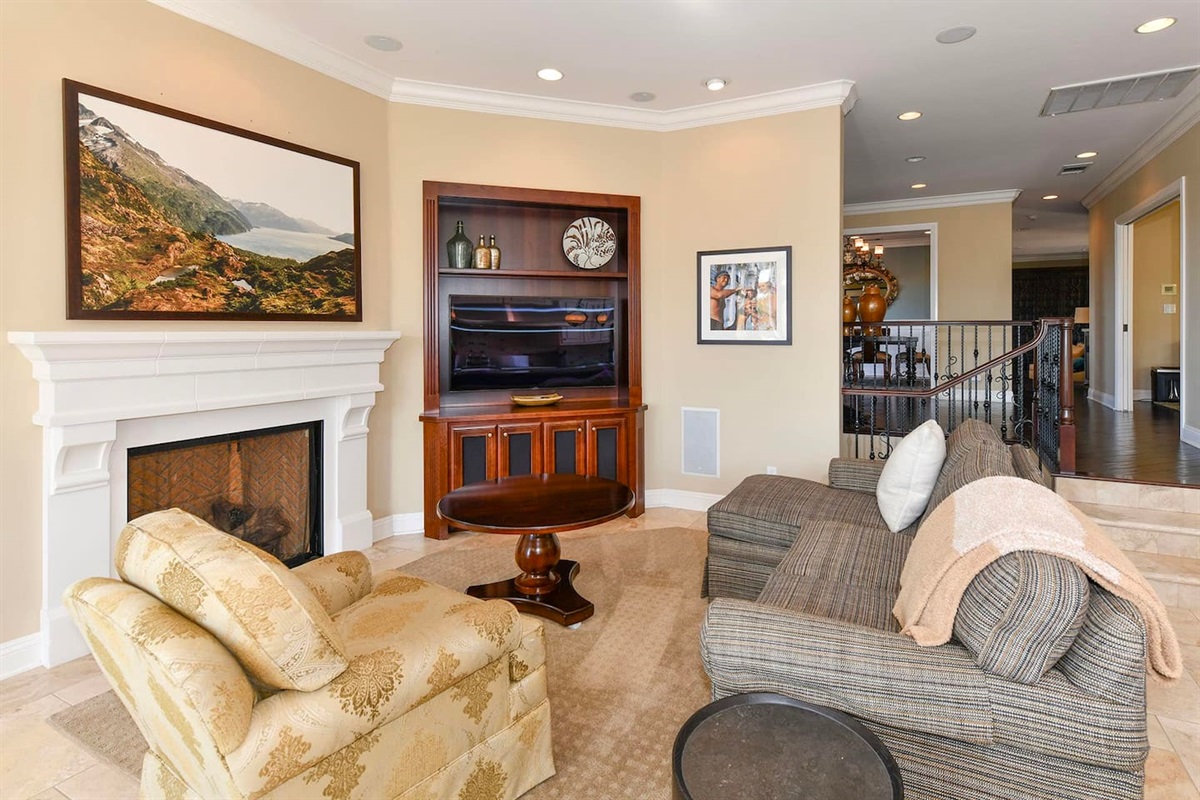 Living area with smart tv next to the kitchen.