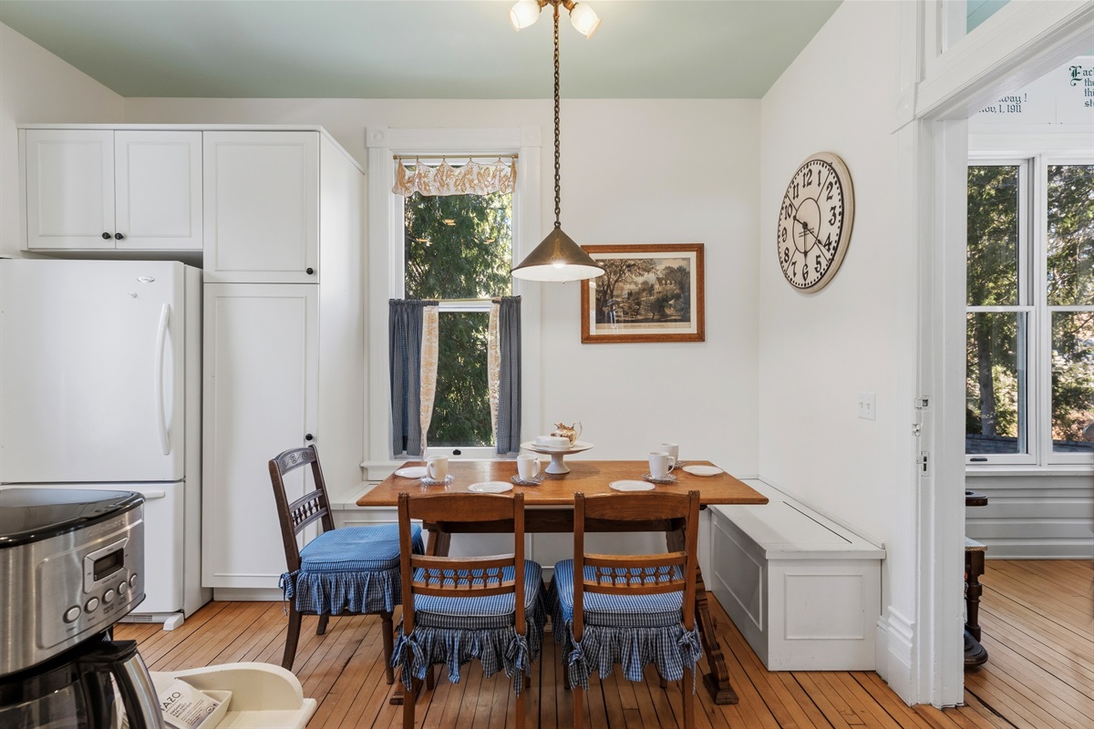 Kitchen dining area w/ table set for shared meals
