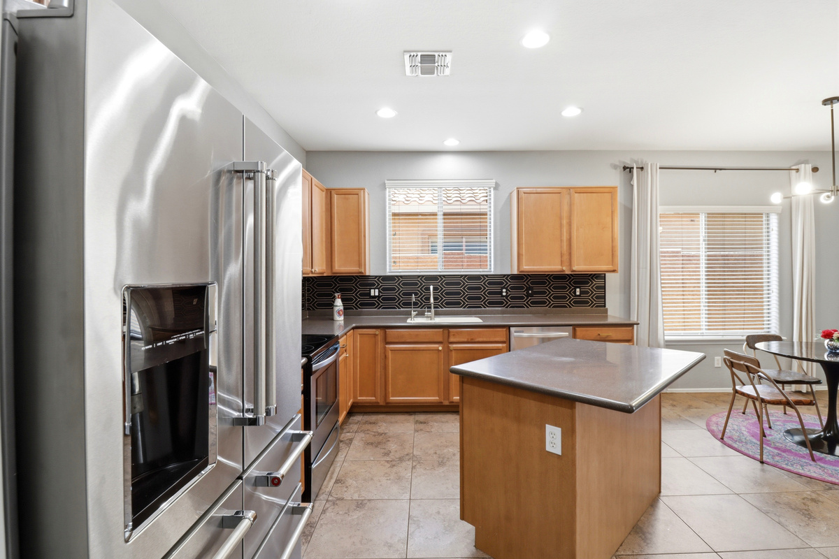 Kitchen with a center island, full appliances, and the dining area just steps away.