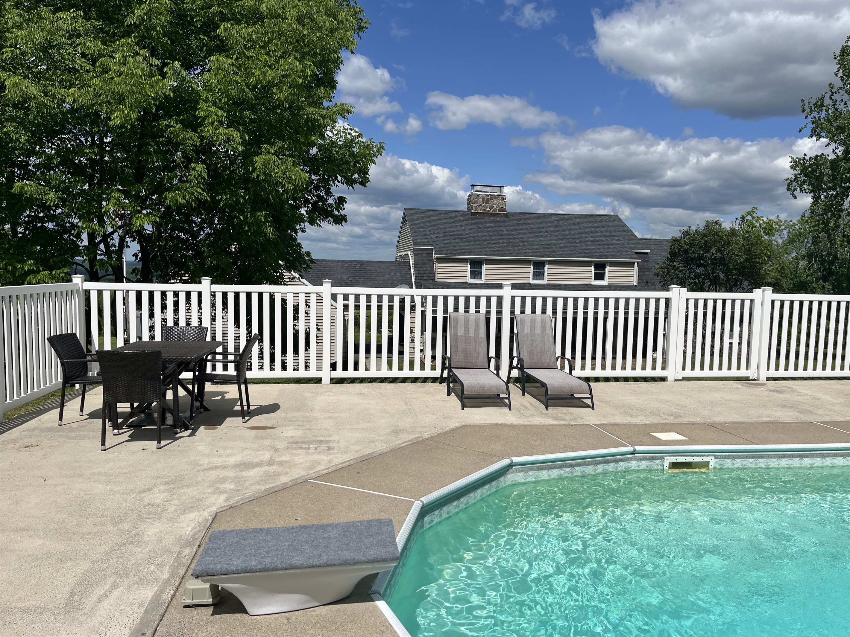 Hilltop Hideaway in-ground pool with pool deck .