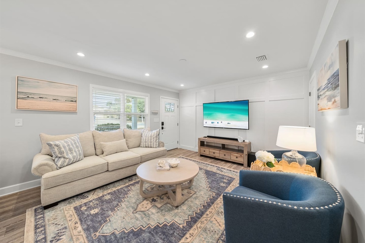Inviting living room area with beautiful natural light and a sleeper sofa. 