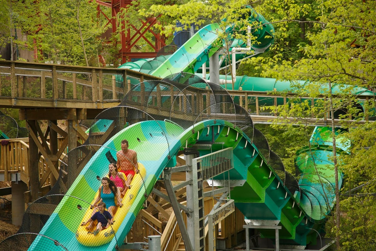 Slide with three friends on the River Rush, Tennessee's first and only water coaster, at Dollywood's Splash Country. 