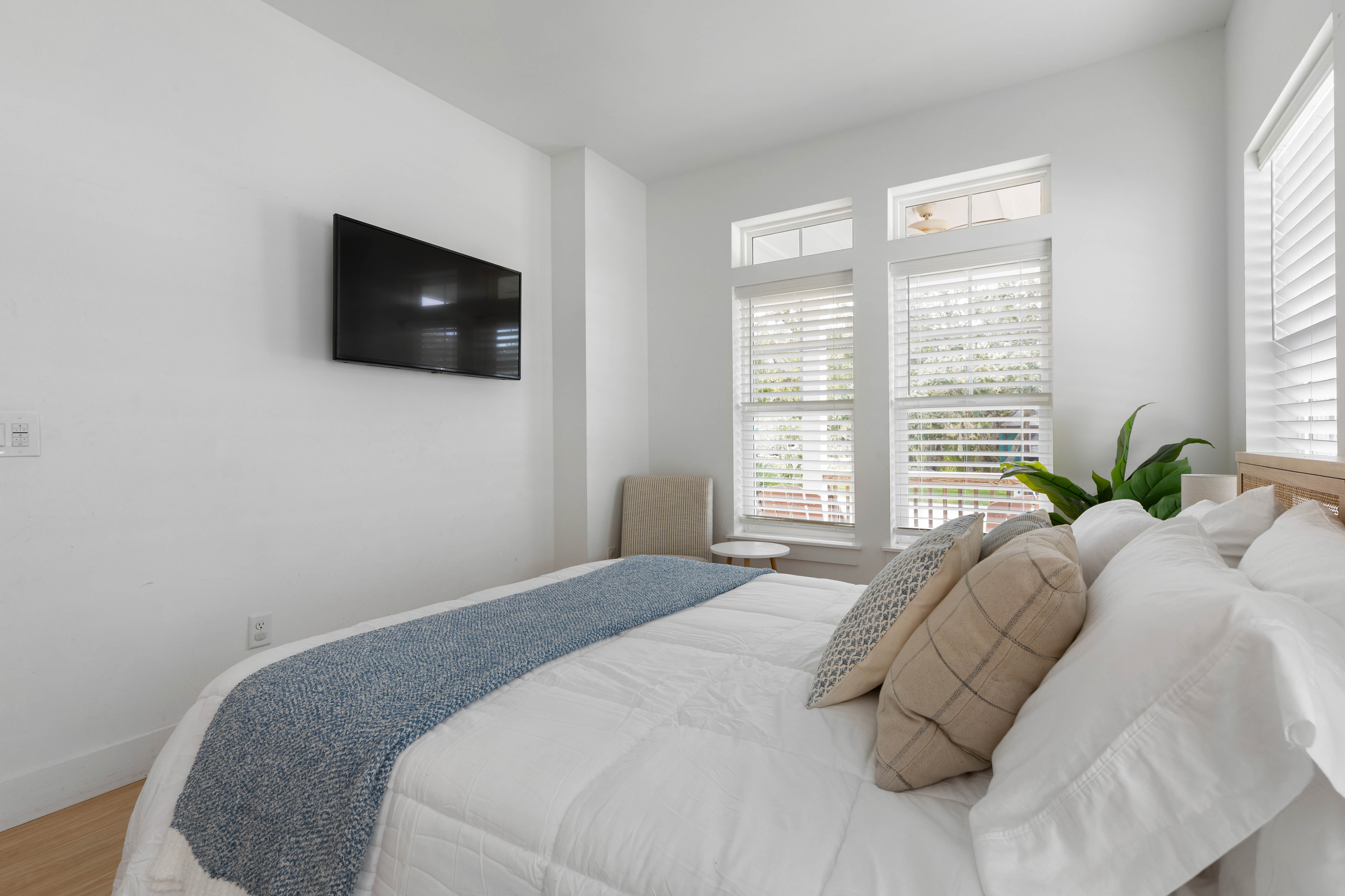 A television on the wall for the slow mornings, shutters you can angle against the sun, and pillows stacked deep. This is the room that tends to get claimed by whoever carries their bag through the door first.