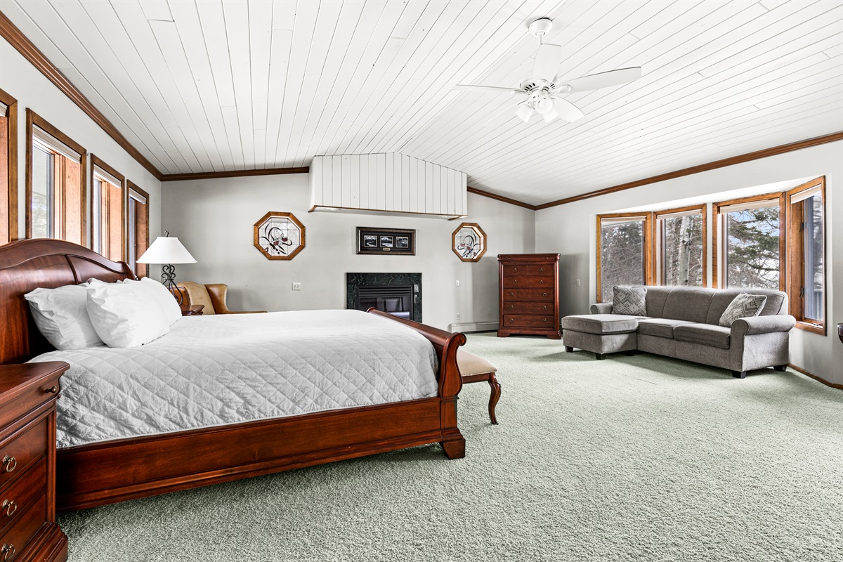 Spacious and inviting primary bedroom with a comfortable king bed, cozy sitting area, and plenty of room to unwind. A relaxing private retreat designed for comfort, rest, and a peaceful stay.