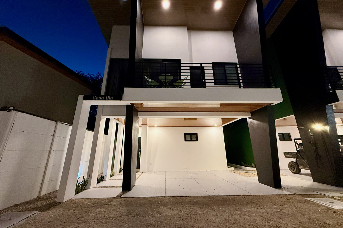 Casa Ola at night. Warm light, the house glows.