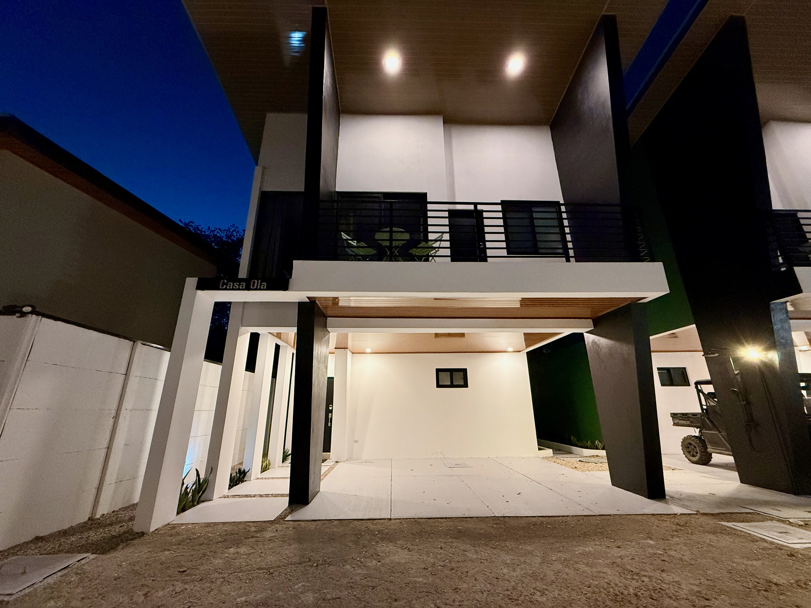 Casa Ola at night. Warm light, the house glows.