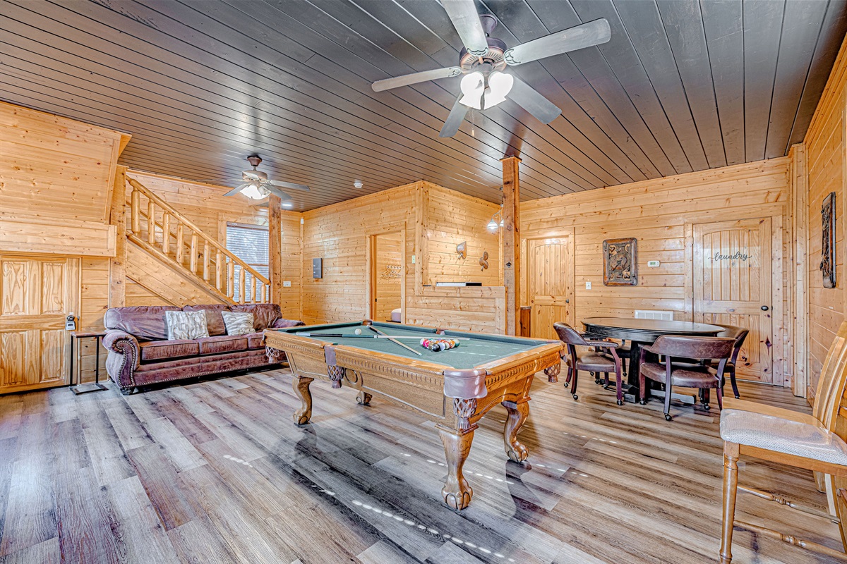 Enjoy playing pool in the lower level of the cabin. Carpet recently replaced with LVP flooring and ceiling painted dark grey to enhance the game room experience.