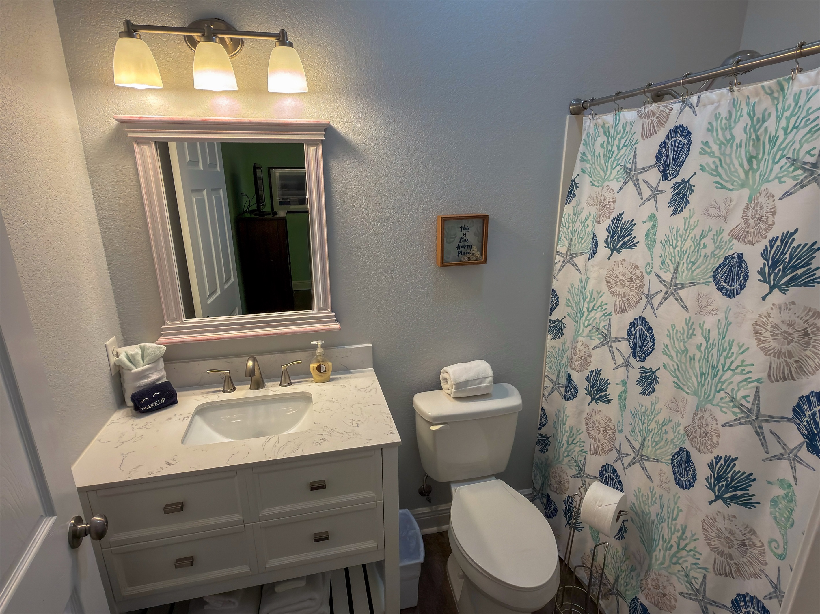 Ensuite Bathroom 4 is designed with comfort in mind, offering a spacious vanity area and a tub and shower combo perfect for rinsing off after beach days.