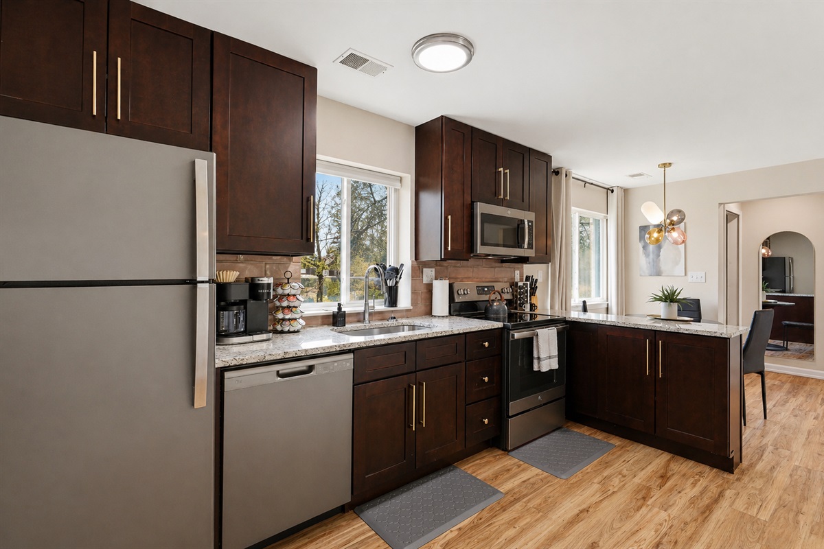 Experience the convenience of a modern kitchen with sleek white cabinets, perfect for your culinary creations.