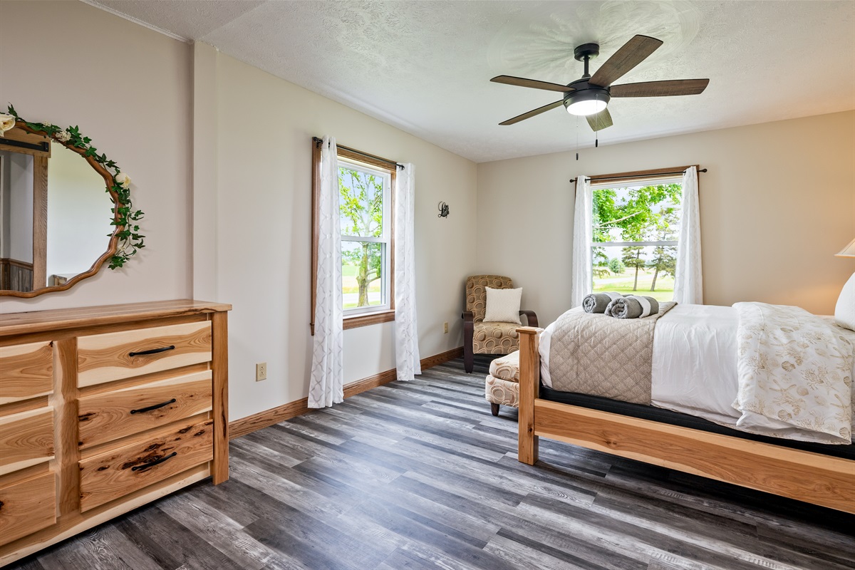 Wake up to natural light in this beautifully furnished bedroom with tasteful details and ample space.
