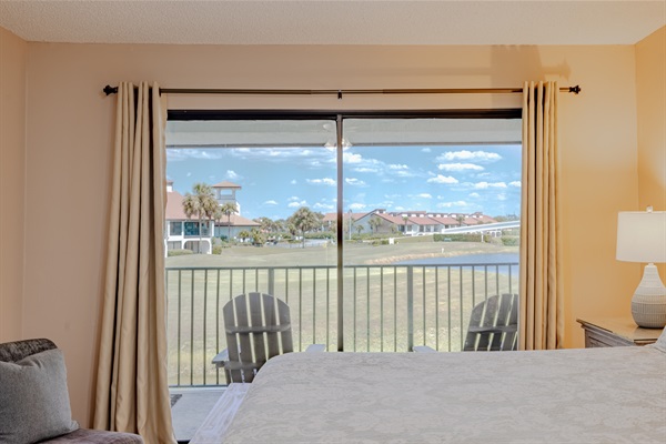 Master bedroom with ceiling fan, ensuite bathroom, smart TT, clothing storage, and golf course view