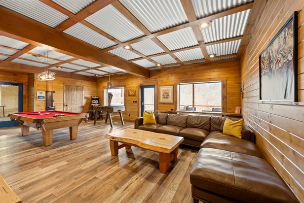 Lower Level Game Room with Lounge Seating, Smart TV, and Pool Table.