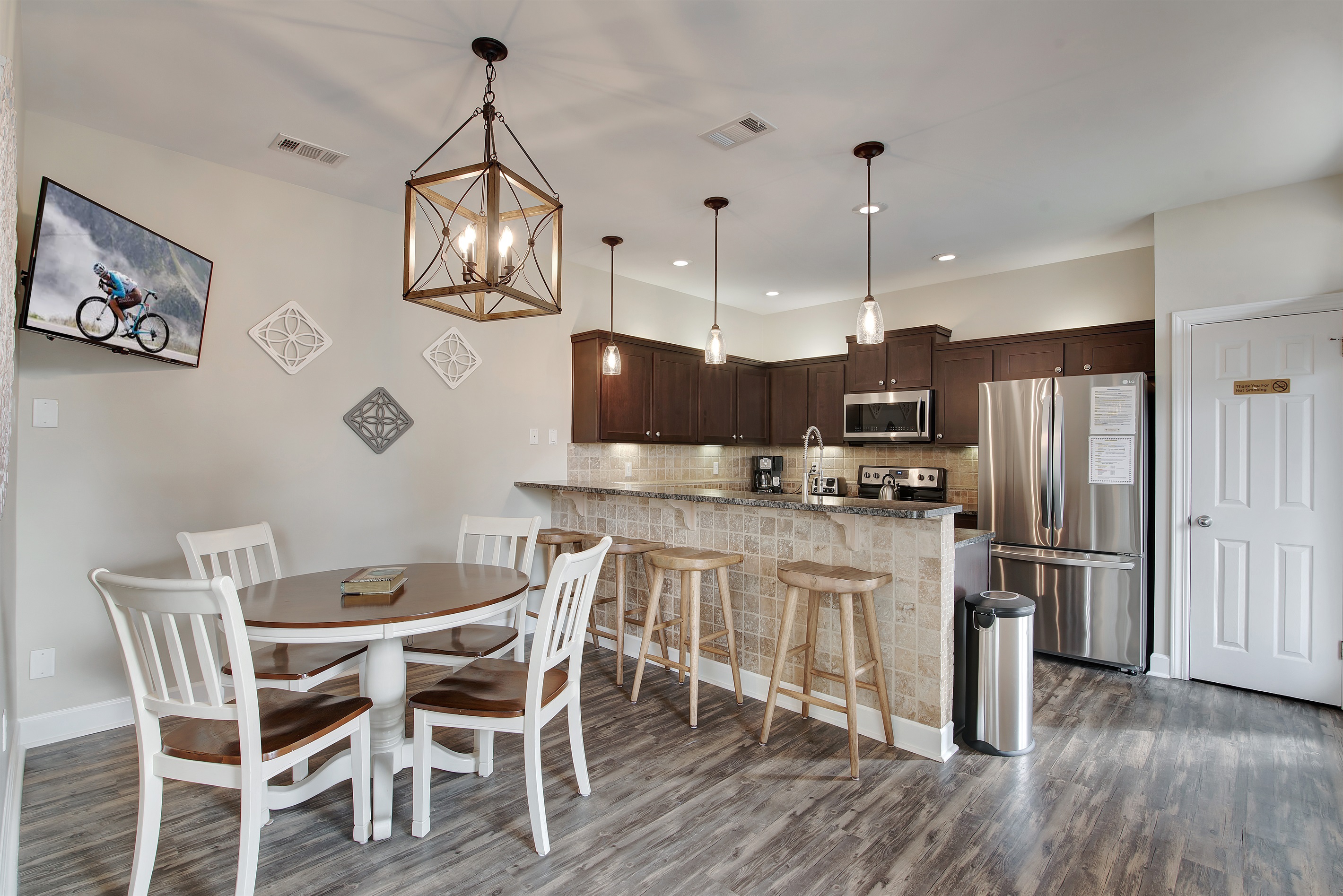 Kitchen and dining area with seating for six and pendant lighting