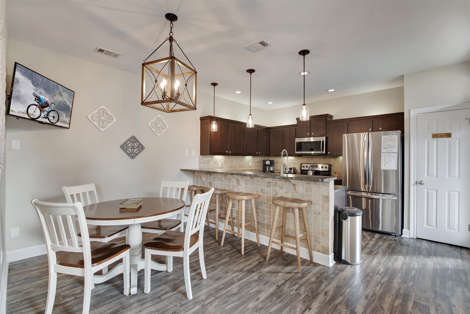 Kitchen and dining area with seating for six and pendant lighting