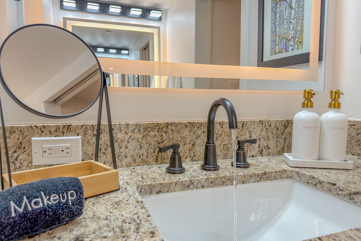 Newly renovated double bathroom vanities - thoughtfully stocked with hand soap, a dedicated makeup towel, and lotion for your convenience.