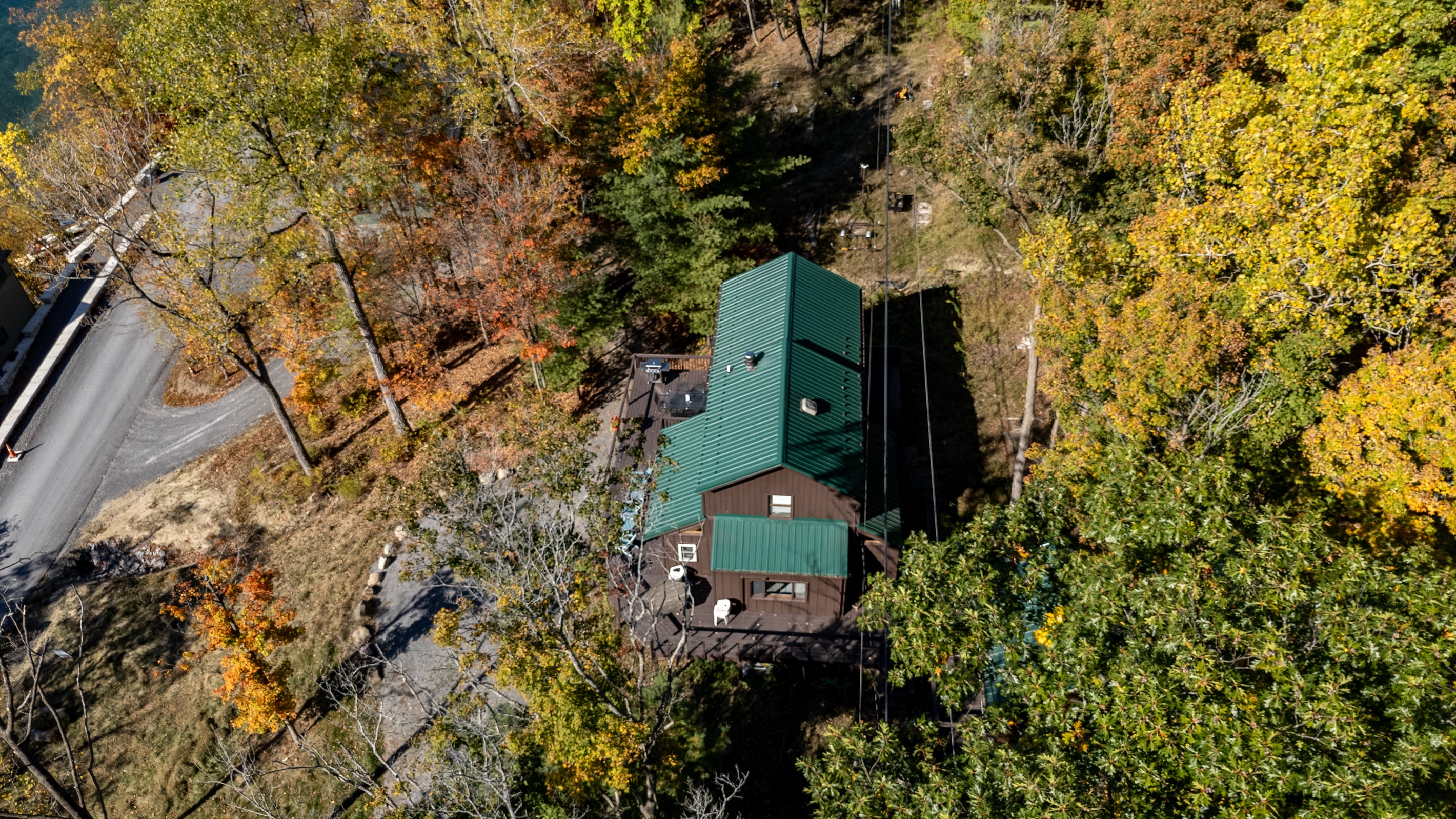 Aerial view of the cabin tucked into the trees above Keuka Lake — your hillside escape.