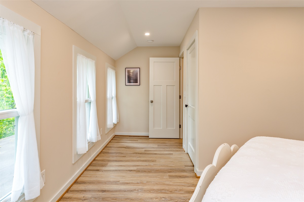 Inviting bedroom with serene views, soft natural light, and a plush white comforter for restful nights. Bedroom #2 double
