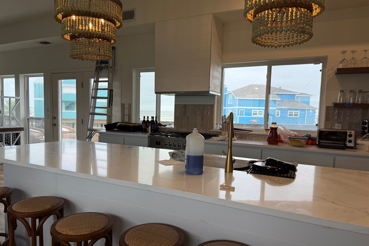 Kitchen sink island gives seating for 6 more at the bar. Beautiful views of the water through a wall of windows. 6 burner gas range completes the ensemble with an under the counter microwave. 5/7/26