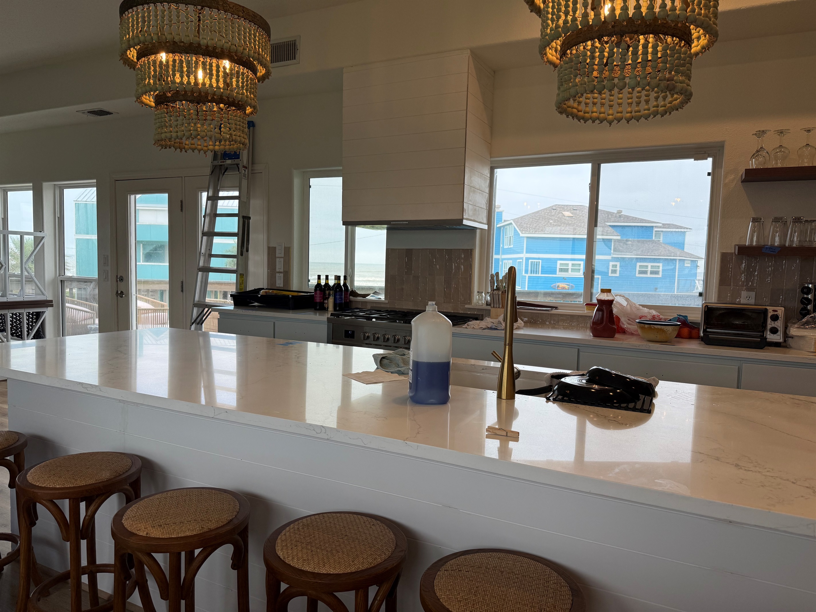 Kitchen sink island gives seating for 6 more at the bar. Beautiful views of the water through a wall of windows. 6 burner gas range completes the ensemble with an under the counter microwave. 5/7/26