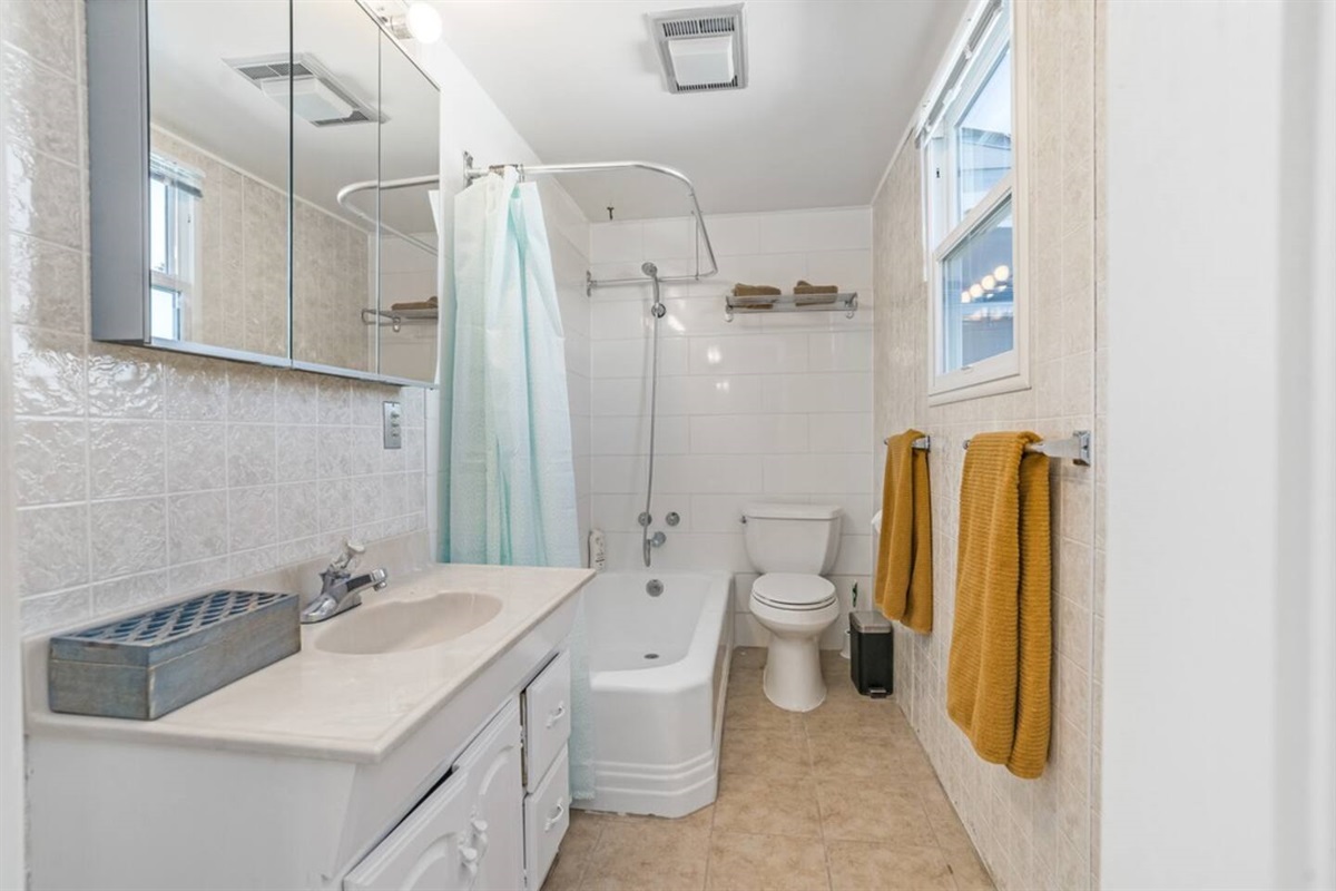 The flat has two full bathrooms for you to enjoy.  The first bathroom has a combination bathtub and shower.