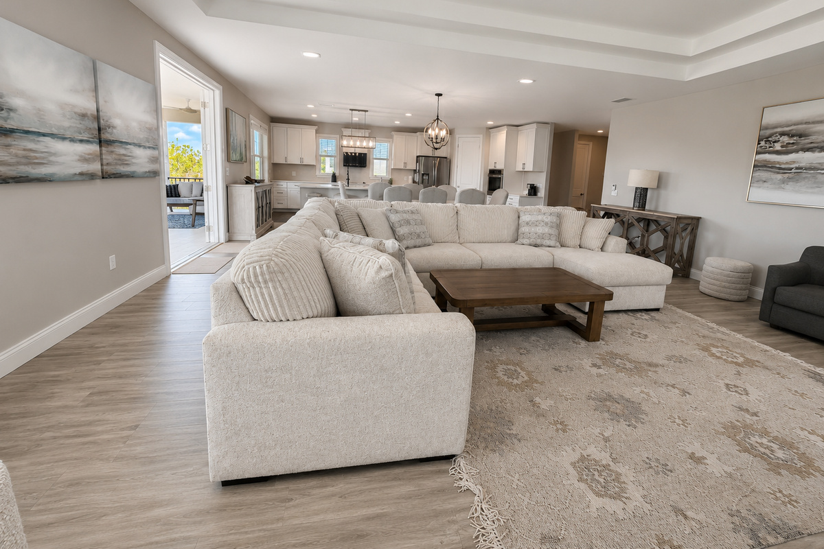 Sunlight, sea breezes, and space to gather—this open great room flows from sofa to table to the balcony beyond. Throw the doors wide, let the indoors and out become one, and watch the whole family drift happily between them all day long.