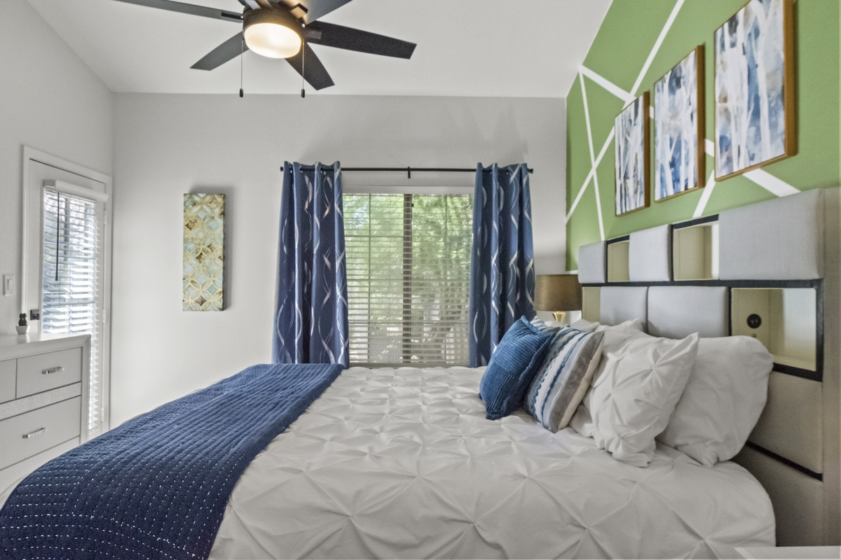 Another calming bed space for guests that features a Roku Smart TV, windows, and a comfortable hybrid mattress. 