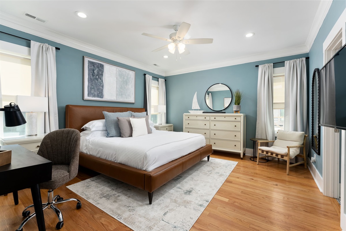Spacious primary suite with king bed, work space, and plenty of room to unwind after a full beach day.