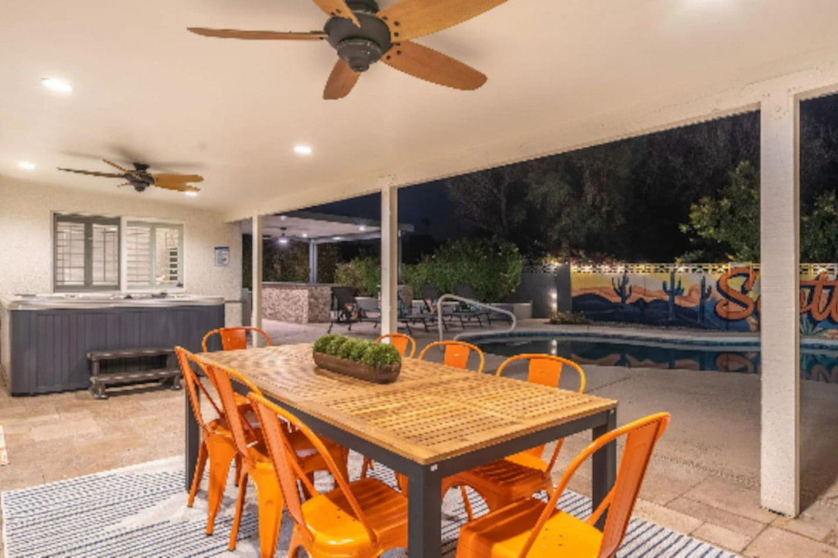Seating for eight under the stars, steps from the pool and hot tub — dinner here comes with its own view.