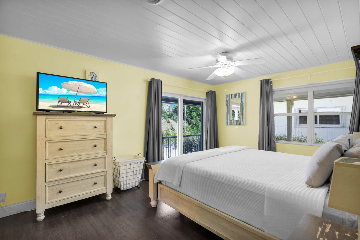 King size bed with private patio in primary bedroom