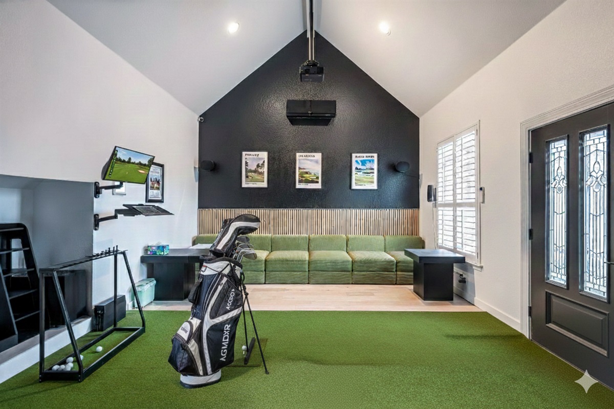 Indoor golf simulator and putting area — enjoy year-round entertainment for all skill levels.